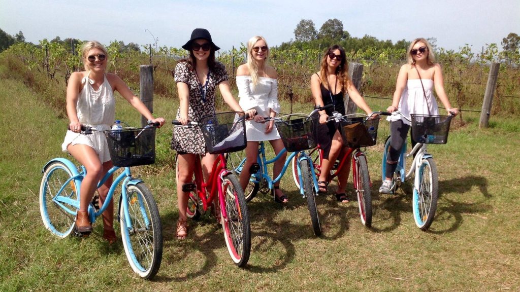 grapemobile bicycle hire girls riding bicycles though the vineyards